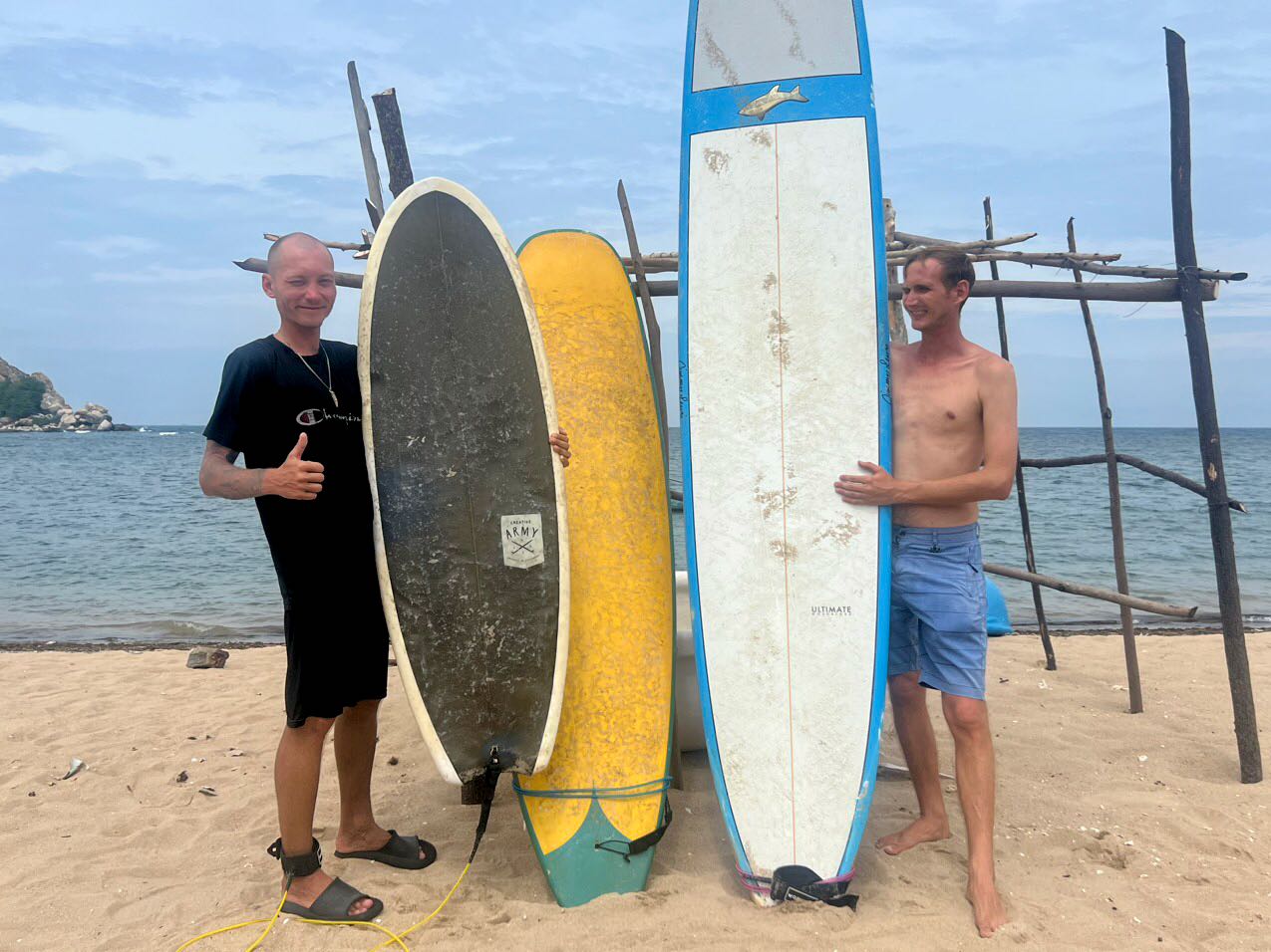 Man Carrying Surfboard In Hang Rai, Vietnam