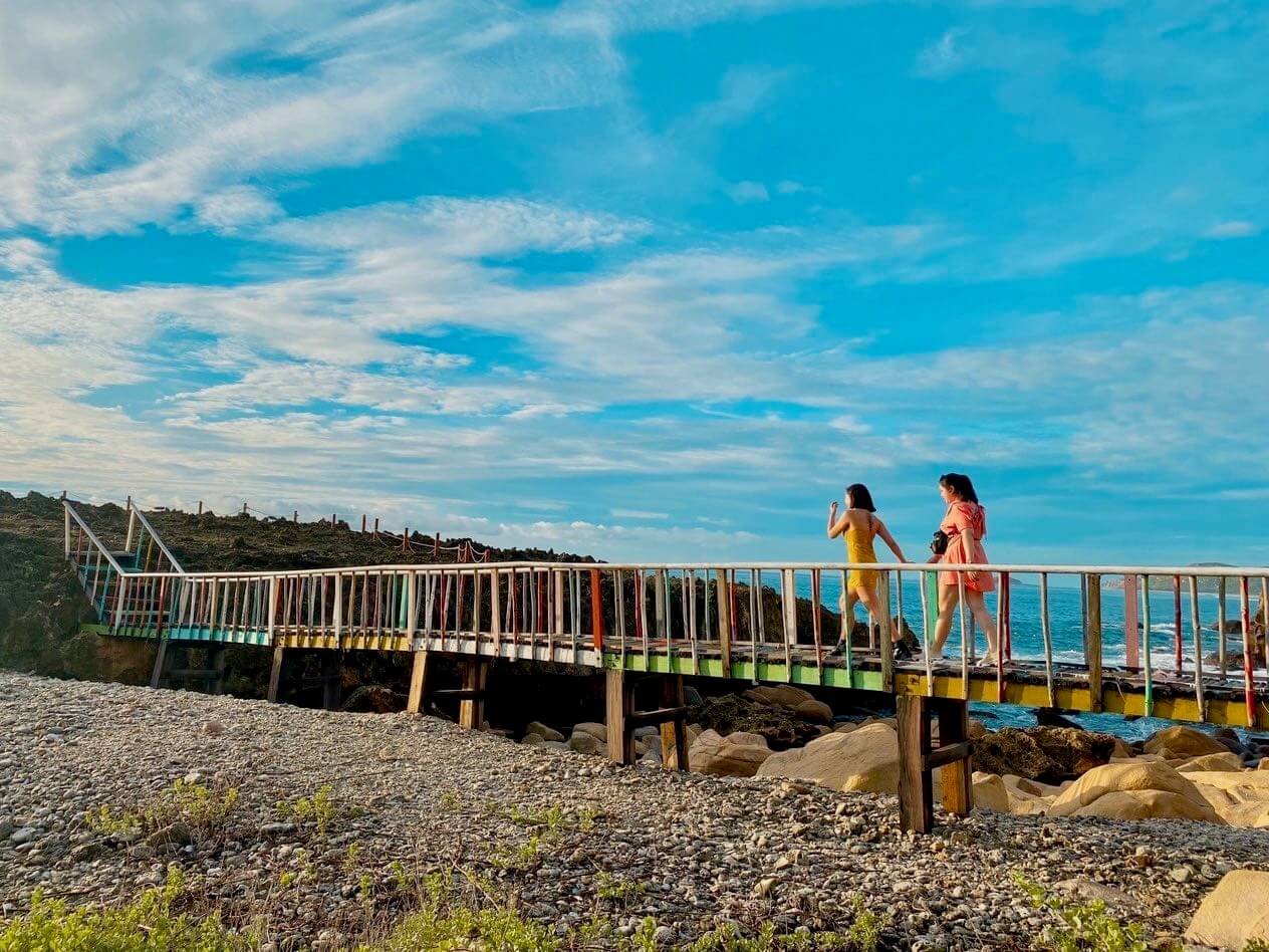 2 Women Crossing Bridge To Hang Rai Fossilized Coral