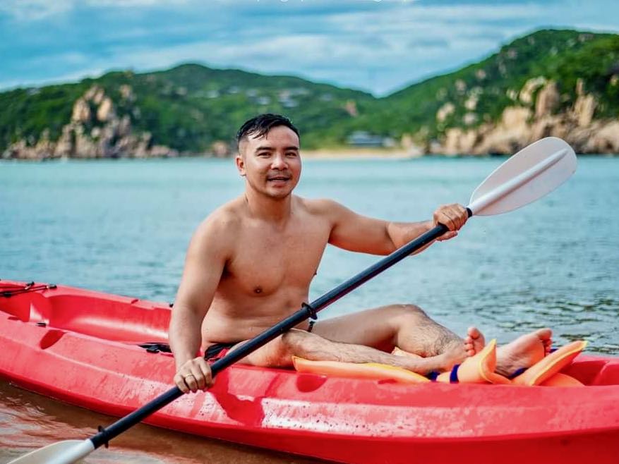 Man Kayaking In Red Kayak On Beach of Vinh Hy Bay, Ninh Than, Vietnam